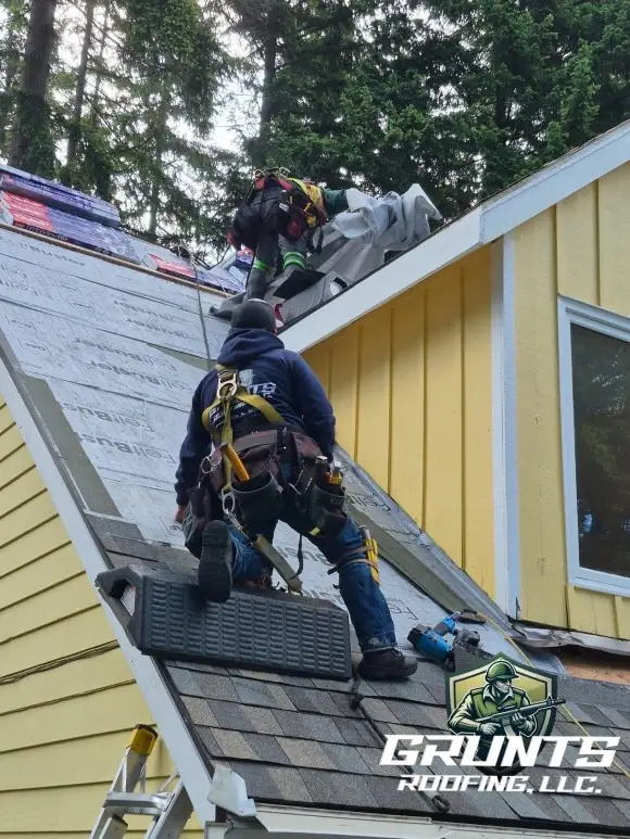 Close up of Grunts Roofing installing GAF shingles on residential home