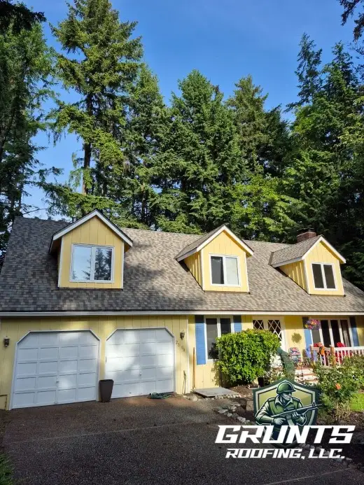 Yellow colored residential home with new roof installed by Grunts Roofing